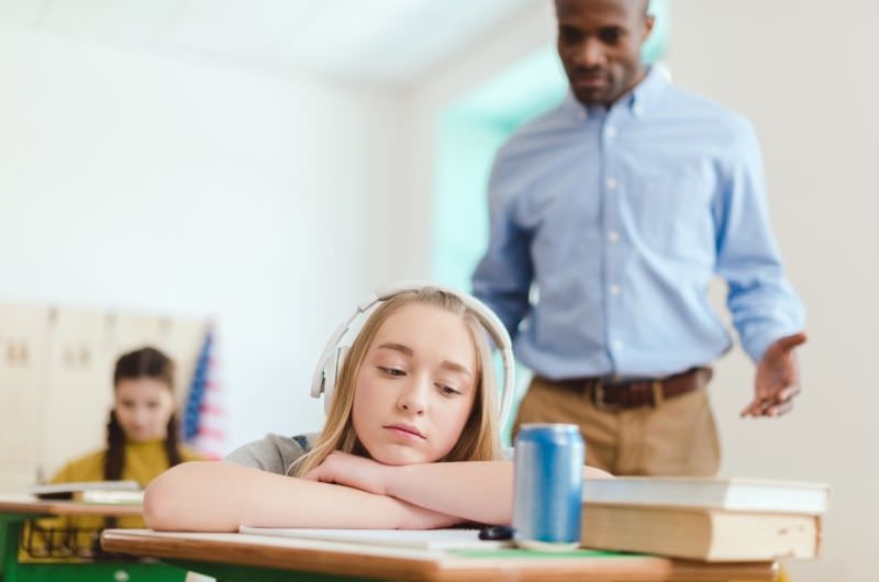 A 13-year-old girl had a red bull earlier and felt a rush, but is now feeling the crash while she is sitting in class at school.