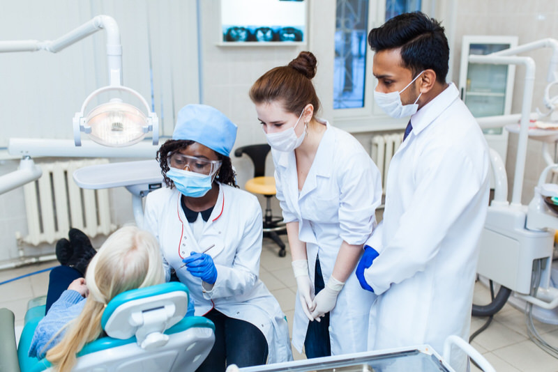 A dental school is a good place to get more affordable dental cleaning done by dental students who are monitored by their teachers.
