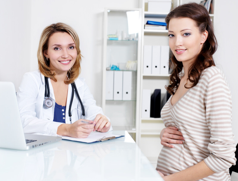 A pregnant woman is meeting with her doctor to discuss having a healthy repeat c-section for her upcoming delivery