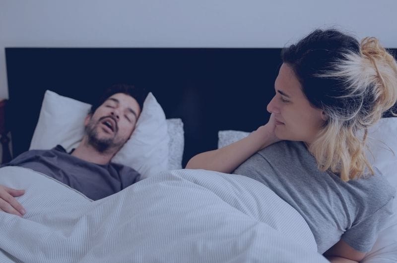 Husband is sleeping and snoring which caused his wife to wake up at night