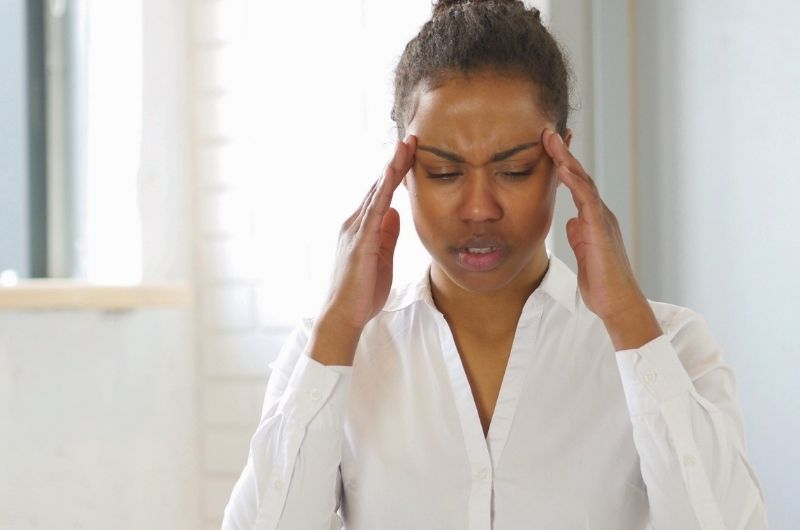 A young woman who's taking Terconazole is having a headache as a side effect of the medicine