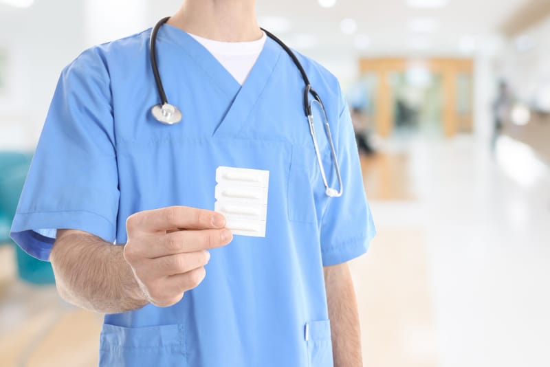 A nurse is providing his patient with a pack of suppositories to use at home
