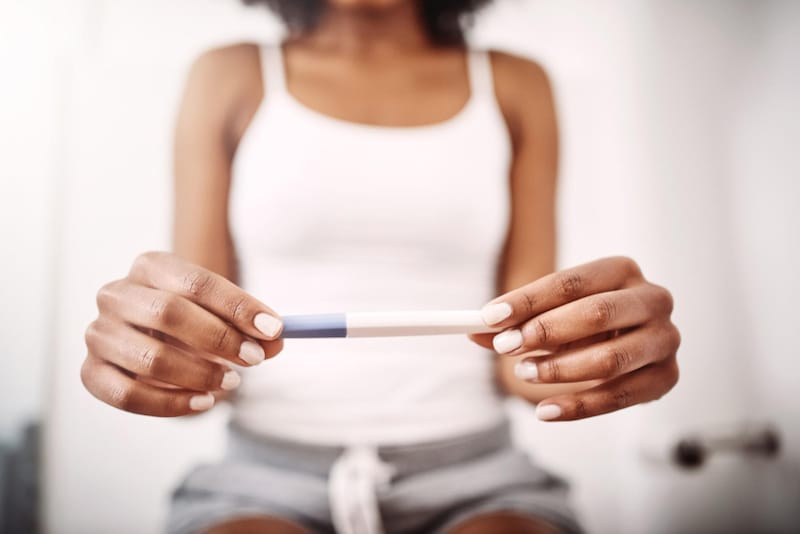 A woman is looking at her pregnancy test results