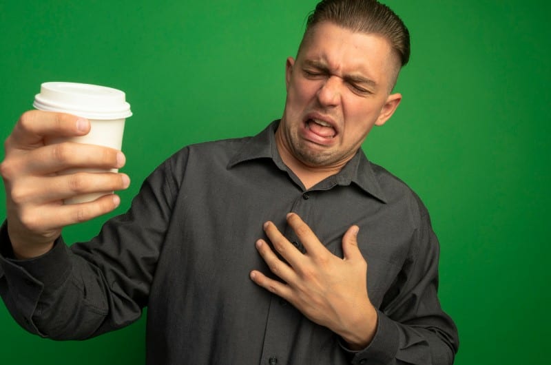 A man experiencing pain in rib cage after drinking coffee.