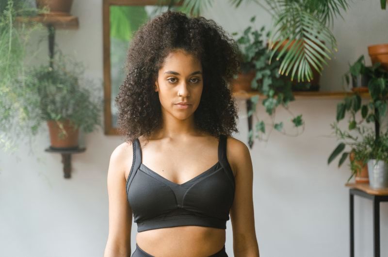 A woman is wearing a comfortable sports bra after recently having a hysterectomy