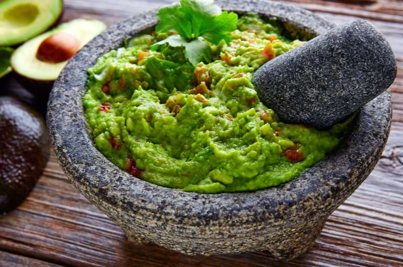 Mashed avocado in a bowl are good for your fertility and overall health.