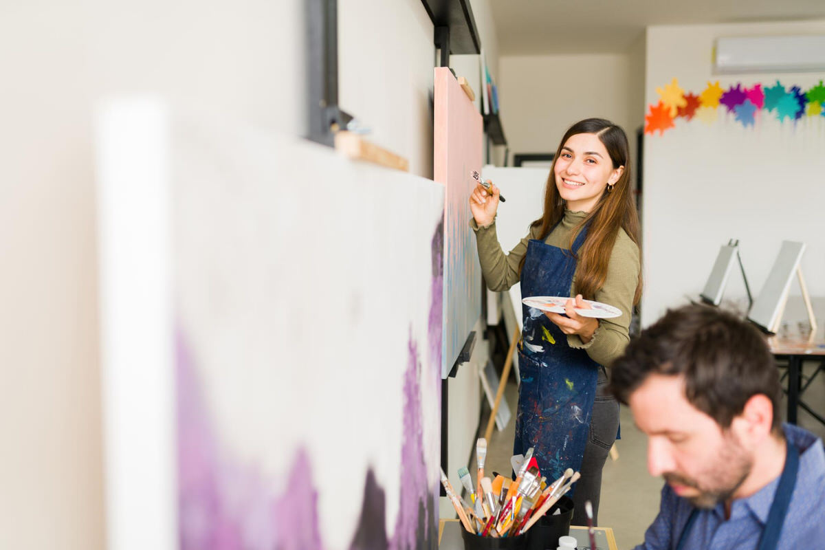 A young woman is painting as a form of art therapy