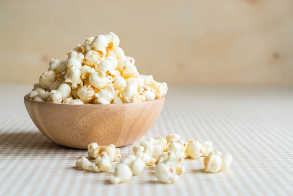 A bowl of home-popped popcorn is better for those with acid reflux, as it can help reduce inflammation