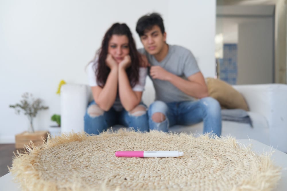 A young couple are waiting patiently for their home pregnancy test results